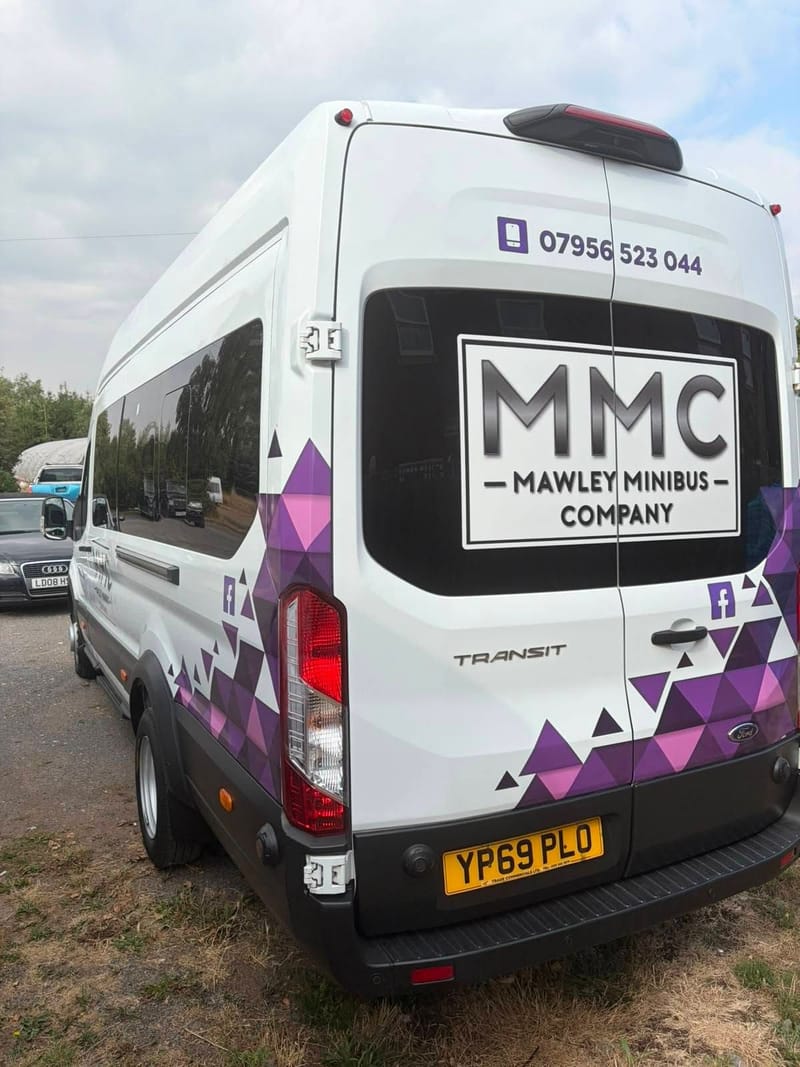 Rear of a Mawley Minibus Ford Transit showing the purple triangle livery
